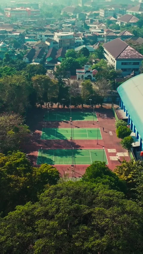 Vertical aerial panorama of tennis complex and sports arena in Yogyakarta Stock Footage 342589616