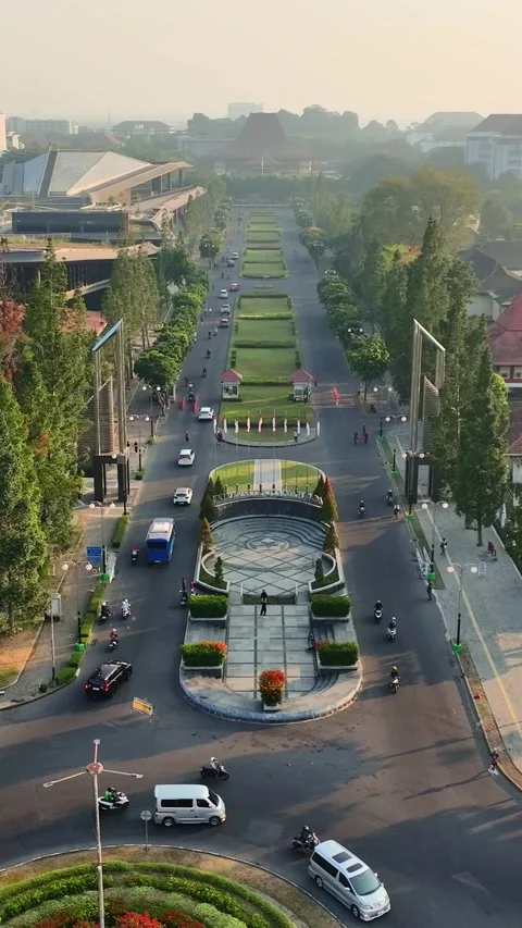 Vertical aerial perspective of landscaped UGM Boulevard and traffic Stock Footage 346739162