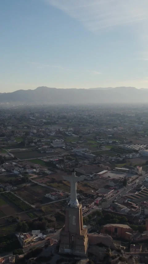 Vertical Aerial Pullback: Christ of Monteagudo Colossal Statue on Castle Stock Footage 332042765
