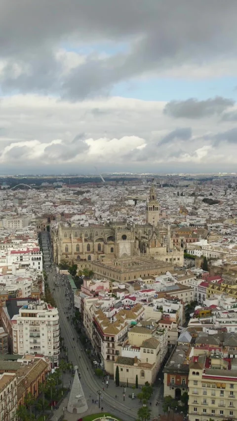 Vertical Aerial Pullback: Seville Skyline with Cathedral on Cloudy Day Stock Footage 332140851
