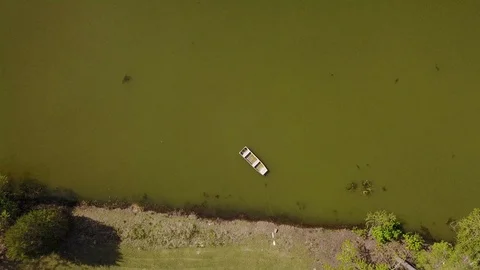 Vertical Aerial Rising Over Small Boat in Pond Stock-Footage 108575877