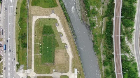 Vertical aerial of river crossing roads and transport lines Stock Footage 321036629