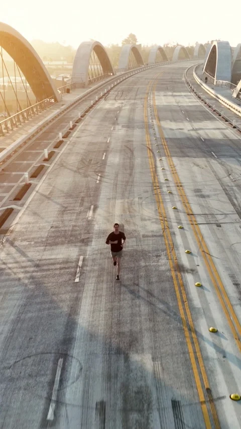 Vertical Aerial Shot of a Athletic Man Jogging in Los Angeles Video stock 337139955