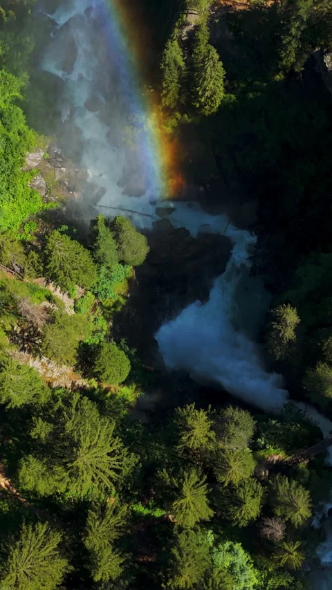 Vertical Aerial Shot of Mountain Waterfall with Rainbow and Forest landscape Vídeos de archivo 334093370