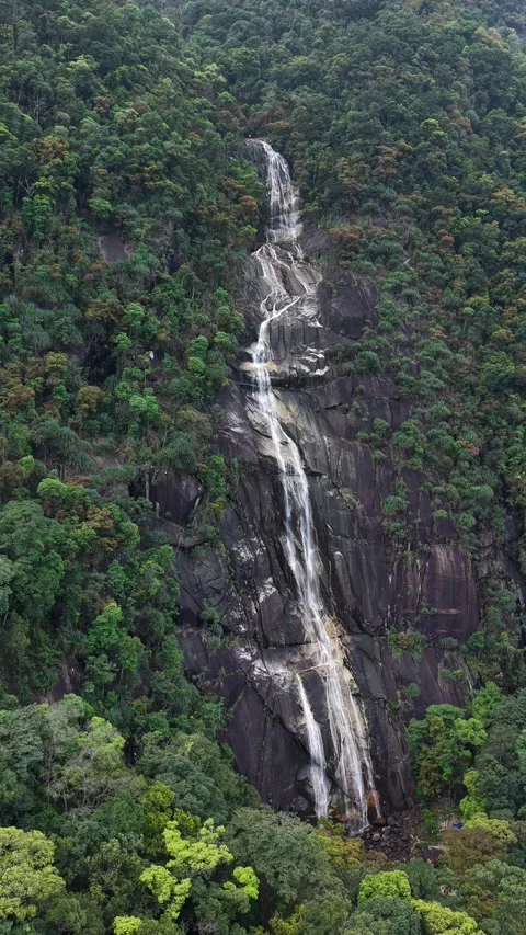 Vertical Aerial Shot of Multi-Tiered Waterfall on Cliffside 스톡 동영상 343698251