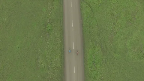 Vertical aerial shot of two cyclists Stock Footage 114349573