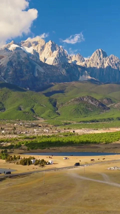 Vertical Aerial Time Lapse of Jade Dragon Snow Mountain and Ganhaizi Meadow Stock Footage 327113156