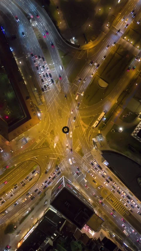 Vertical aerial top down night time lapse of huge busy intersection with 스톡 동영상 328490202