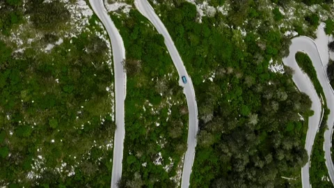 Vertical aerial top down view of mountain serpentine road with moving cars Stock Footage 246958872