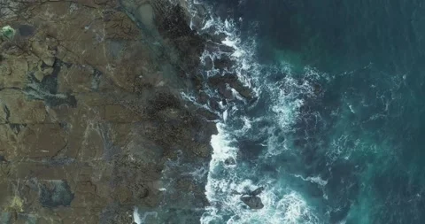 Vertical aerial top down view of rocky shore. The Concept of Geology. Video stock 325972616