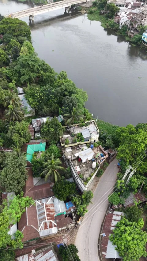 Vertical aerial top down view of a narrow bridge crossing a rural river Stock Footage 341526373