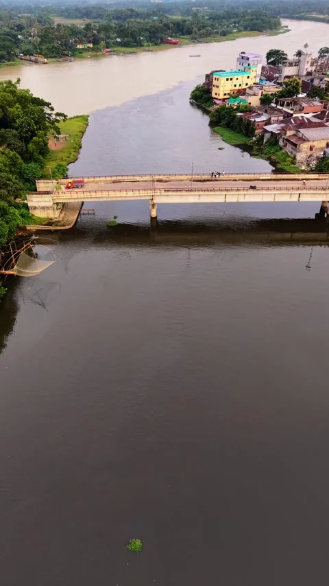Vertical aerial top down view of a narrow bridge crossing a rural river Stock Footage 341526409