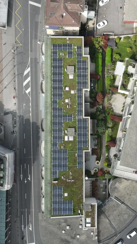 Vertical Aerial Top View of Green Roof with Solar Panels on Urban Building Video stock 332829224