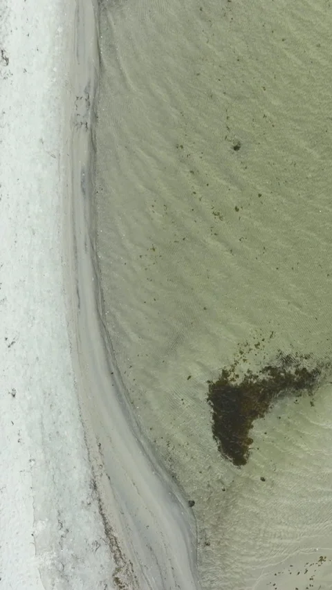 Vertical Aerial Top View Of Sandy Beach And Shallow Sea Water Stock Footage 342249971