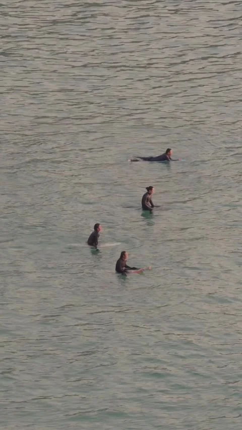 Vertical Aerial vertical view of surfers waiting for waves in the ocean Stockbeeldmateriaal 331300972