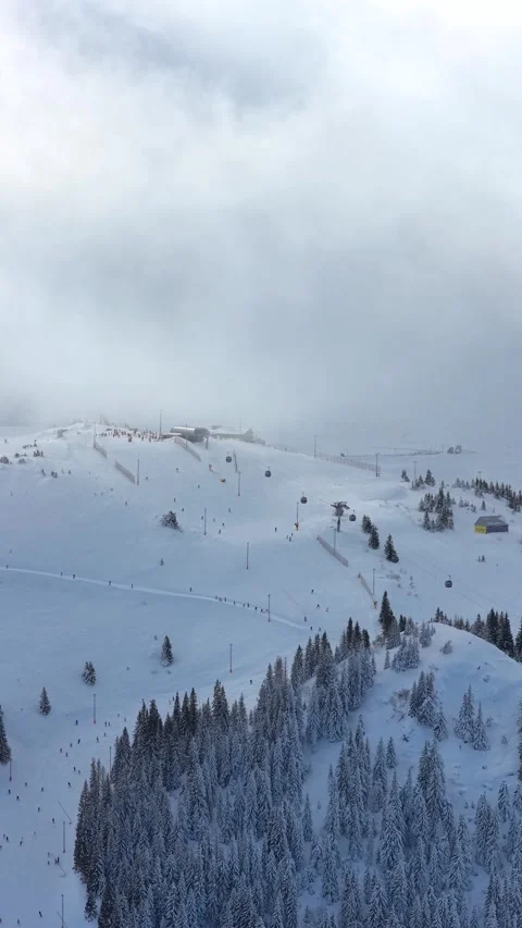 Vertical aerial video of alpine ski peak with gondola and slopes, optimized.. Video stock 326777557