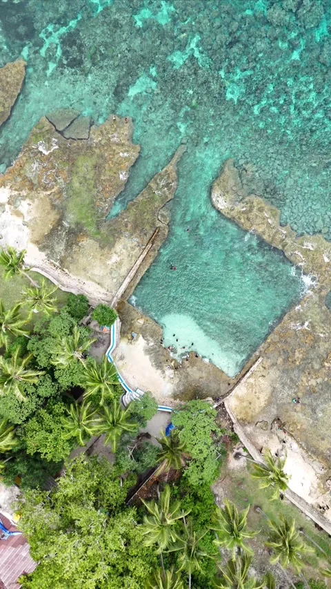 Vertical aerial video beautiful beach with natural pool in Ambon city 10 Stock Footage 305302244
