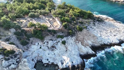 Vertical aerial view of ancient archaeological ruins by the sea. Stock Footage 327674540