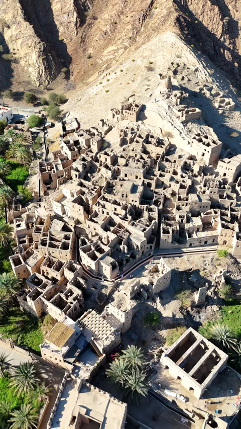 Vertical Aerial View of Ancient Mud Brick Village with Palm Trees Birkat Al Mouz Stock Footage 333475106