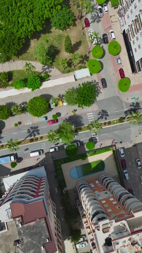 Vertical aerial view of apartment building under construction with materials and Stock Footage 341808780