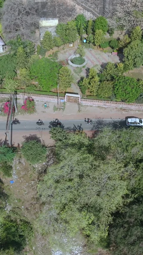 Vertical Aerial View of Bikers Riding Along Gwalior Fort Road Stock Footage 344389801