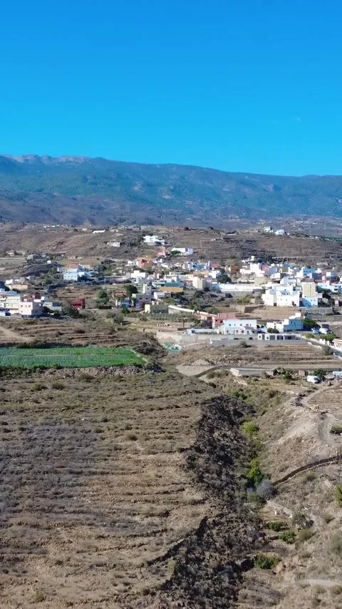 Vertical Aerial View of Black Volcanic Ground and Greenhouses in Tenerife Stock Footage 344851192