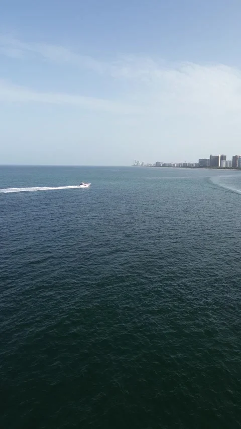 Vertical Aerial View of Boat Sailing Along Miami Coastline at Golden Hour Stock Footage 341834094