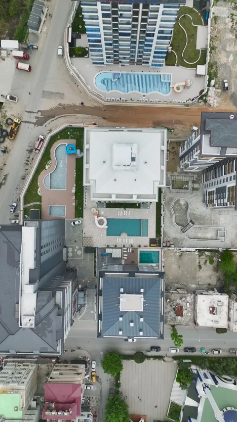 Vertical Aerial View Contemporary Pool Area with Light Stone Texture and Blue Stock Footage 341775991