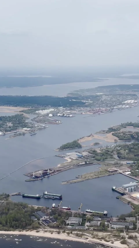 Vertical aerial view of the Daugava River estuary near the Baltic Sea, showing Stock Footage 338004591