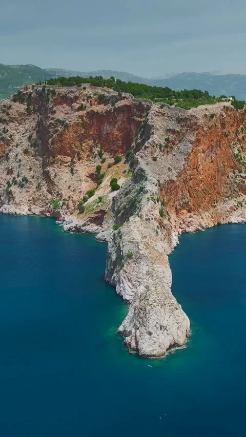 Vertical Aerial View Dramatic Rocky Peninsula Surrounded by Deep Blue Sea 库存影片 341811389