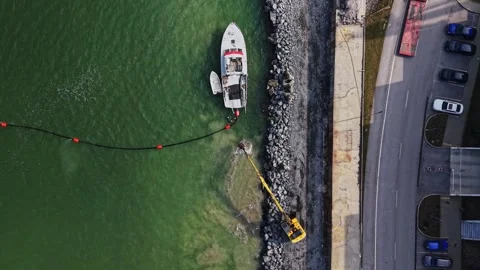 Vertical aerial view of dredging operations in port Vidéo 338187142