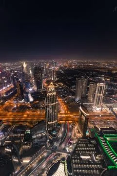 A vertical aerial view of Dubai downtown at night from the top of Burj Khalif Stock Photos
