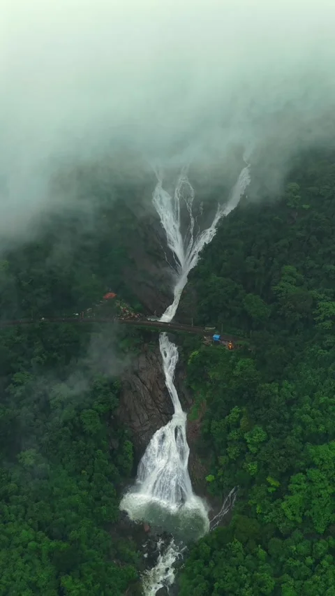 Vertical Aerial View of Dudhsagar Waterfall Surrounded by Lush Forest in Goa Stock Footage 344272943