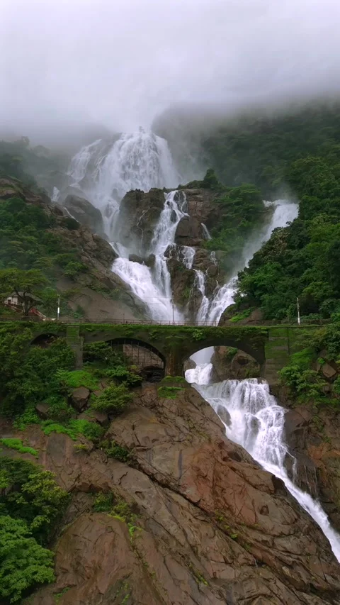 Vertical Aerial View of Dudhsagar Waterfall Surrounded by Lush Forest in Goa Stock Footage 344273171