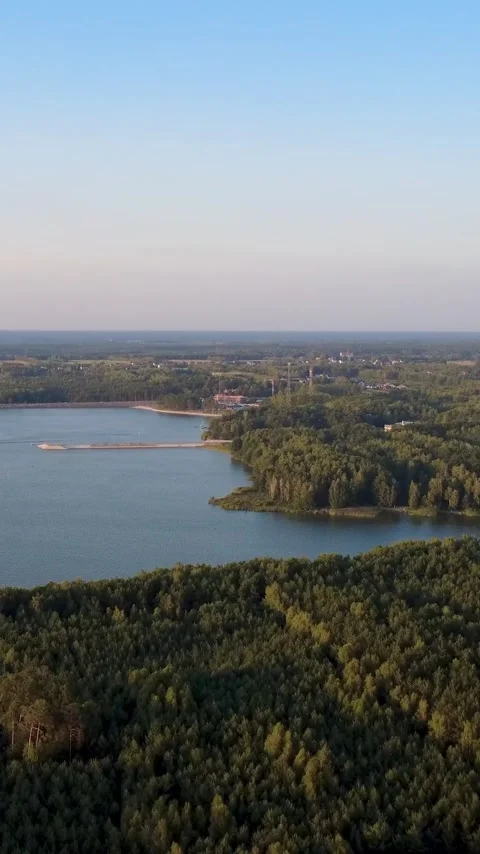 Vertical Aerial View of a Forest Lake in Poland at Golden Hour Stock Footage 344851179