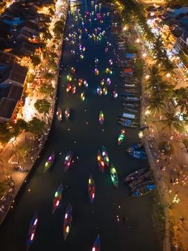 Vertical Aerial View of Glowing Lantern Boats on River in Hoi An Vietnam at Stock Photos