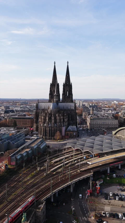 Vertical aerial view of Gothic Cologne Cathedral and central train station with Stock Footage 324209648