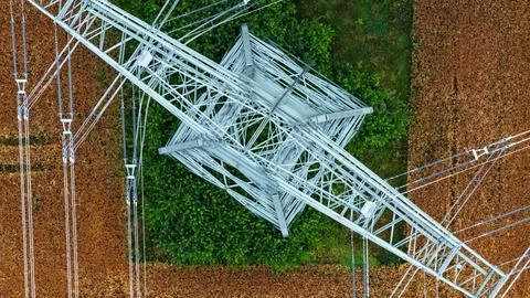 Vertical Aerial View of High-Voltage Transmission Tower Above Farmland Stock Photos