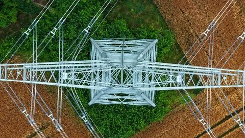 Vertical Aerial View of High-Voltage Transmission Tower Above Farmland Stock Photos