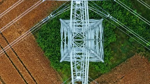 Vertical Aerial View of High-Voltage Transmission Tower Above Farmland Stock Photos