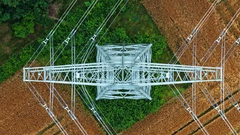 Vertical Aerial View of High-Voltage Transmission Tower Above Farmland Stock Photos
