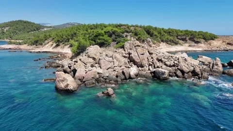 Vertical aerial view of large rock formations and boulders along the coast. Stock Footage 327673862