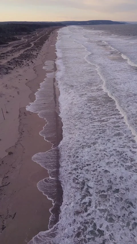 Vertical Aerial View of Long Sandy Beach and Foamy Sea Waves Видео 347068968