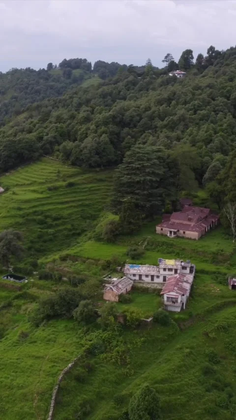 Vertical Aerial View of Lush Green Hills and Winding Mountain Roads in Almora Stock Footage 345485330