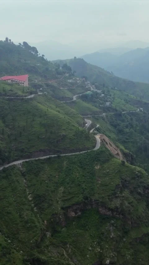 Vertical Aerial View of Lush Green Hills and Winding Mountain Roads in Almora Stock Footage 345485719