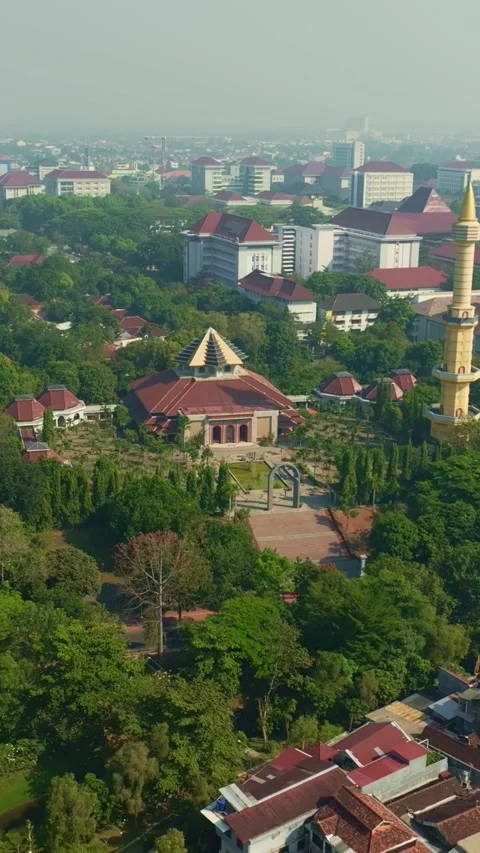 Vertical aerial view of mosque complex within green Yogyakarta neighborhood 動画素材 342577540