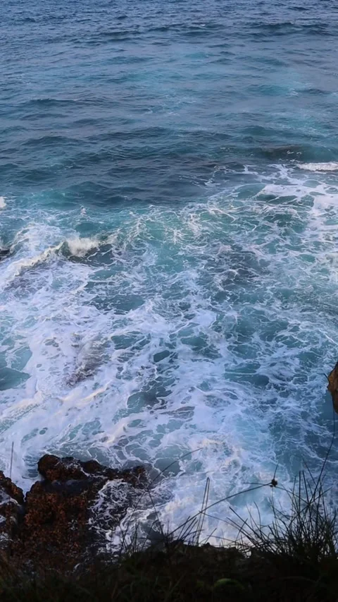Vertical Aerial View of Ocean Waves Crashing on Rocks Stock Footage 342033329