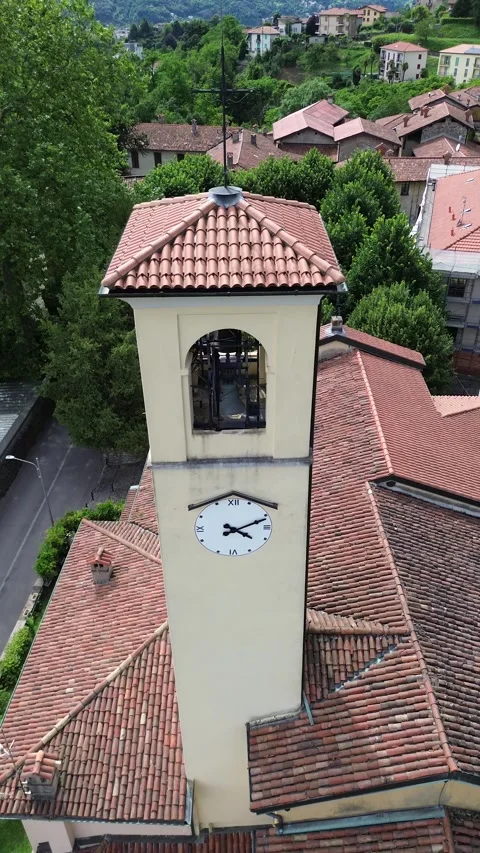 Vertical Aerial view with orbital effect of bell tower of Santa cecilia Chu.. Stock Footage 279342024