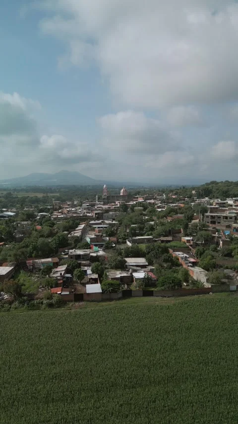 Vertical aerial view over the rooftops of a rural town Stock Footage 342062101