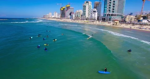 Vertical Aerial view of People using surfboards at Tel Aviv beach, Israel Stock Footage 220348233